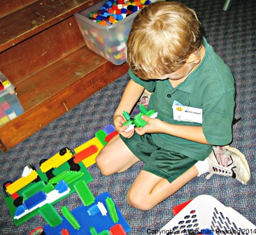 First day, boy playing with stickle bricks